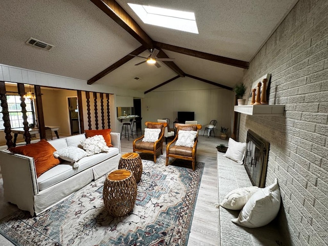 3302 Southland Blvd, San Angelo, TX 76904 - living room with wood finished floors, lofted ceiling, a textured ceiling, a fireplace, and a skylight