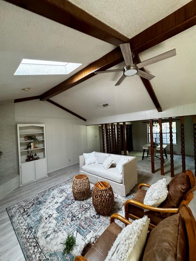 3302 Southland Blvd, San Angelo, TX 76904 - living room with a textured ceiling, wood finished floors, a skylight, and a ceiling fan