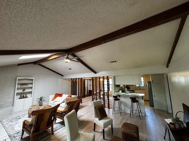3302 Southland Blvd, San Angelo, TX 76904 - living area featuring light wood-style floors, a textured ceiling, and a ceiling fan
