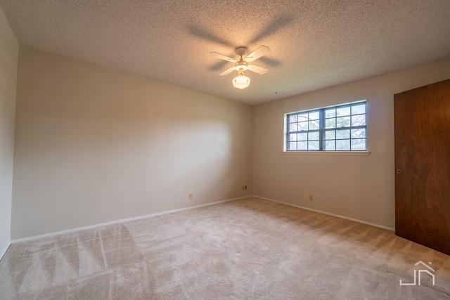 3302 Southland Blvd, San Angelo, TX 76904 - unfurnished room with a ceiling fan, light colored carpet, and a textured ceiling