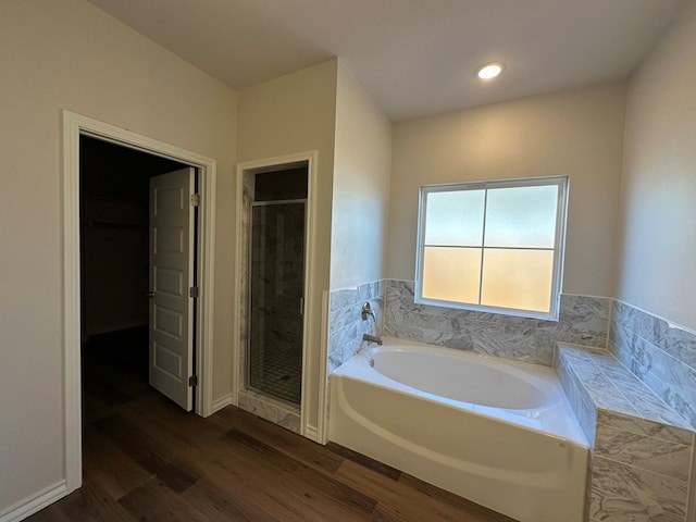 bathroom featuring hardwood / wood-style flooring and shower with separate bathtub