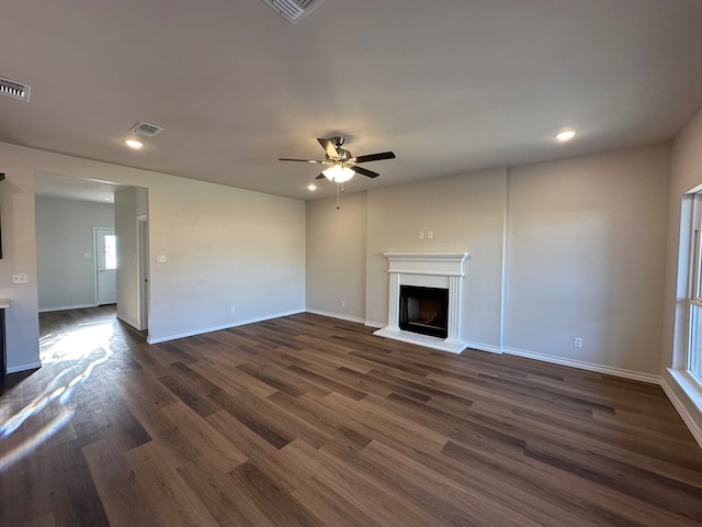 unfurnished living room featuring dark hardwood / wood-style floors and ceiling fan