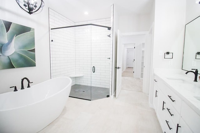 bathroom featuring vanity and independent shower and bath