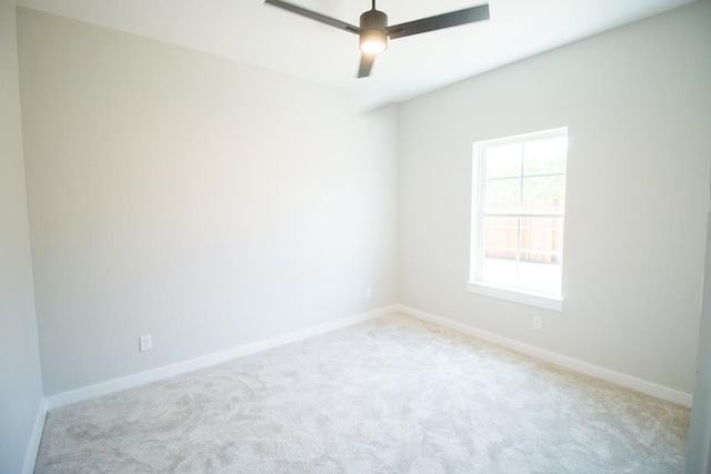 unfurnished room with ceiling fan and light colored carpet