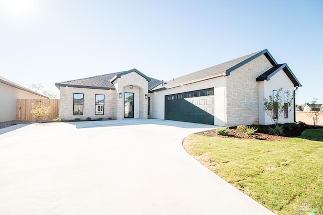 view of front of property with a garage and a front yard