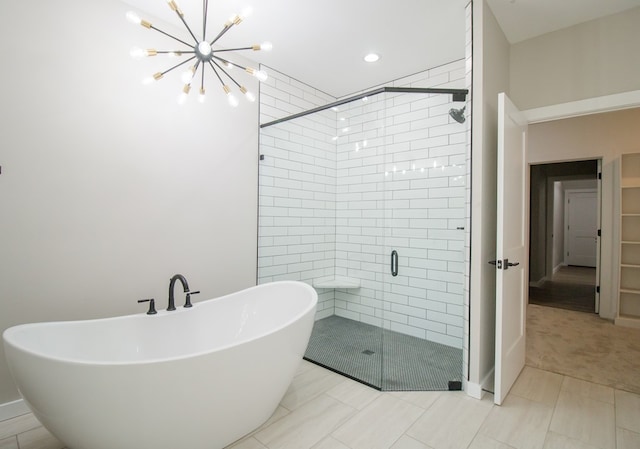 bathroom featuring tile patterned flooring, separate shower and tub, and an inviting chandelier