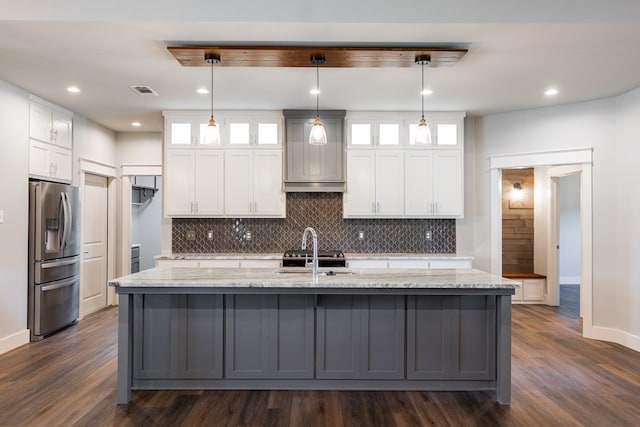 1906 Colonial Dr, San Angelo, TX 76904 - kitchen with backsplash, stainless steel fridge, dark wood-type flooring, white cabinetry, and recessed lighting