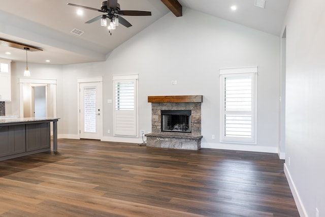 1906 Colonial Dr, San Angelo, TX 76904 - unfurnished living room featuring a fireplace, a ceiling fan, beamed ceiling, dark wood finished floors, and high vaulted ceiling