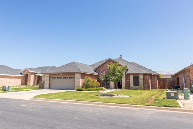 1906 Colonial Dr, San Angelo, TX 76904 - ranch-style house featuring brick siding, roof with shingles, a garage, and concrete driveway
