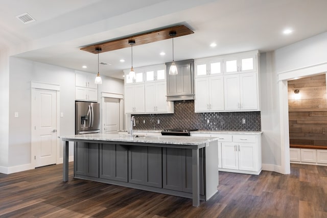 1906 Colonial Dr, San Angelo, TX 76904 - kitchen featuring decorative backsplash, stainless steel fridge, dark wood-style floors, white cabinets, and recessed lighting