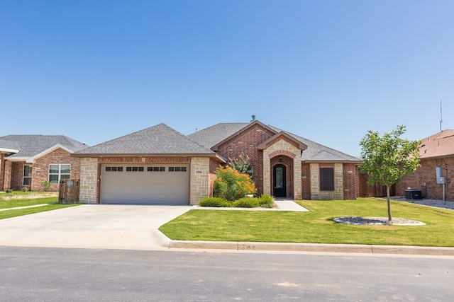 1906 Colonial Dr, San Angelo, TX 76904 - view of front of house featuring brick siding, a shingled roof, an attached garage, and a front yard