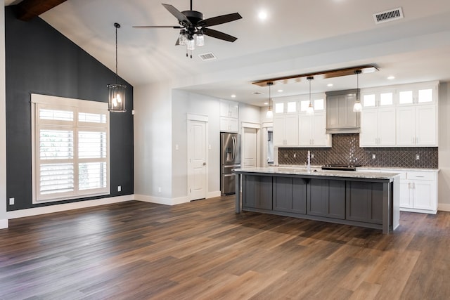 1906 Colonial Dr, San Angelo, TX 76904 - kitchen with white cabinetry, stainless steel fridge with ice dispenser, tasteful backsplash, glass insert cabinets, and recessed lighting