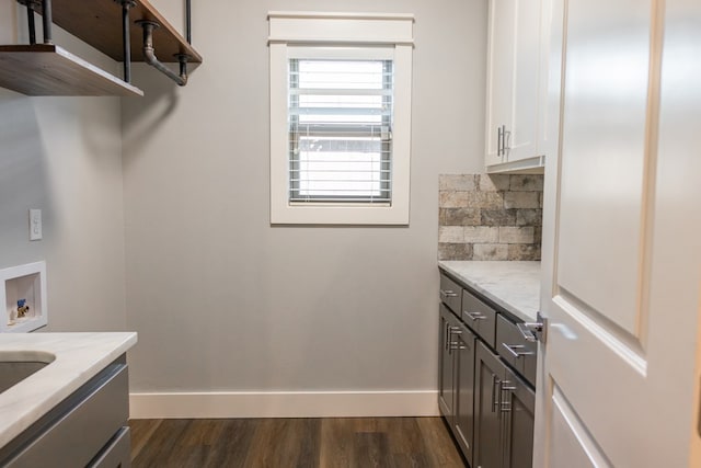 1906 Colonial Dr, San Angelo, TX 76904 - laundry area featuring washer hookup, cabinet space, and dark wood-style floors