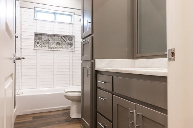 1906 Colonial Dr, San Angelo, TX 76904 - bathroom featuring wood finished floors, vanity, and bathtub / shower combination