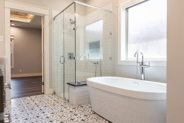 1906 Colonial Dr, San Angelo, TX 76904 - bathroom featuring plenty of natural light, a freestanding bath, a shower stall, and tile patterned flooring