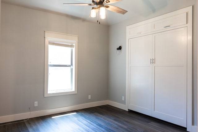1906 Colonial Dr, San Angelo, TX 76904 - unfurnished bedroom featuring dark wood finished floors, a closet, and a ceiling fan