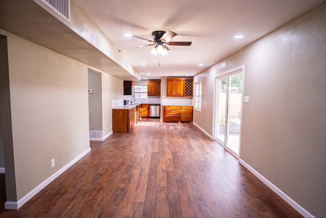 1521 S Jackson St, San Angelo, TX 76904 - kitchen featuring brown cabinets, stainless steel dishwasher, dark wood finished floors, light countertops, and ceiling fan