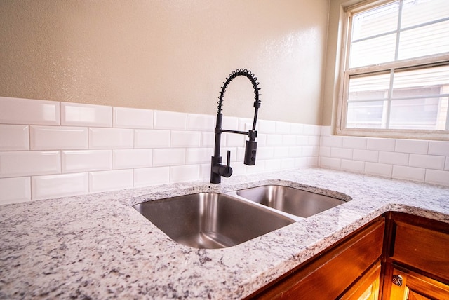 1521 S Jackson St, San Angelo, TX 76904 - kitchen view of a sink, tasteful backsplash, and light stone counters