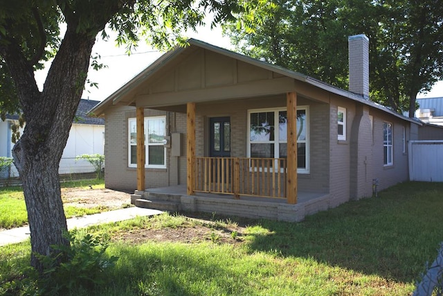 115W 3rd St, San Angelo, TX 76903 - bungalow with covered porch, brick siding, and a chimney