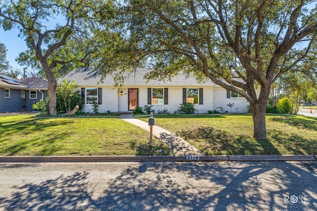 ranch-style home with a front lawn