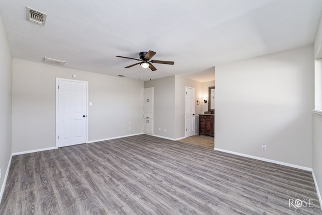 3119 Woodland Cir, San Angelo, TX 76904 - spare room with visible vents, a ceiling fan, baseboards, and wood finished floors