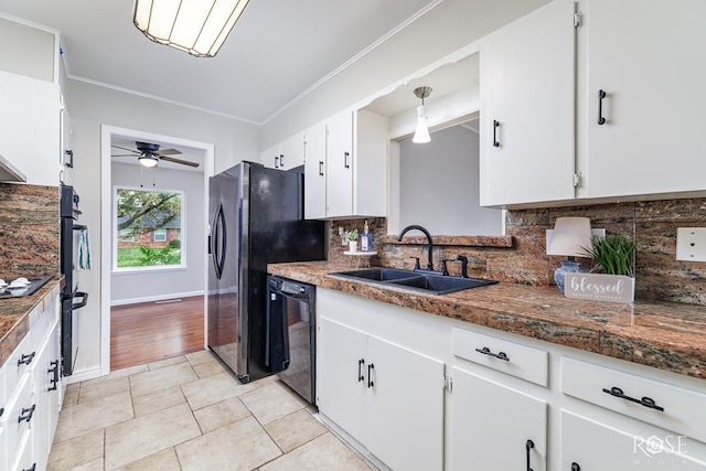 3119 Woodland Cir, San Angelo, TX 76904 - kitchen featuring a ceiling fan, tasteful backsplash, a sink, white cabinets, and black appliances