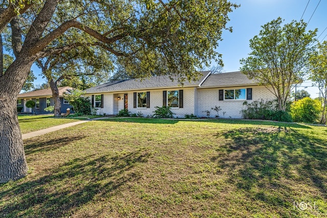 single story home featuring a front lawn