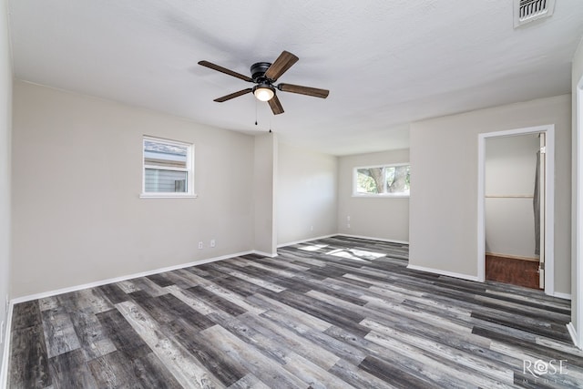 unfurnished room with dark hardwood / wood-style flooring, ceiling fan, and a textured ceiling