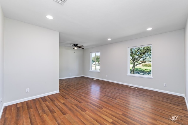 spare room with ceiling fan and dark hardwood / wood-style flooring