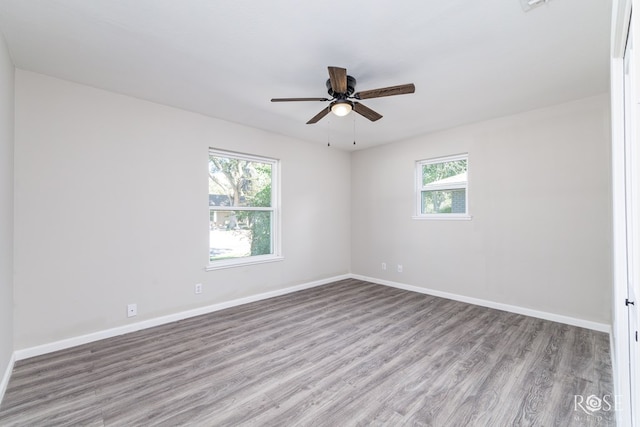 spare room featuring ceiling fan, plenty of natural light, and light hardwood / wood-style flooring