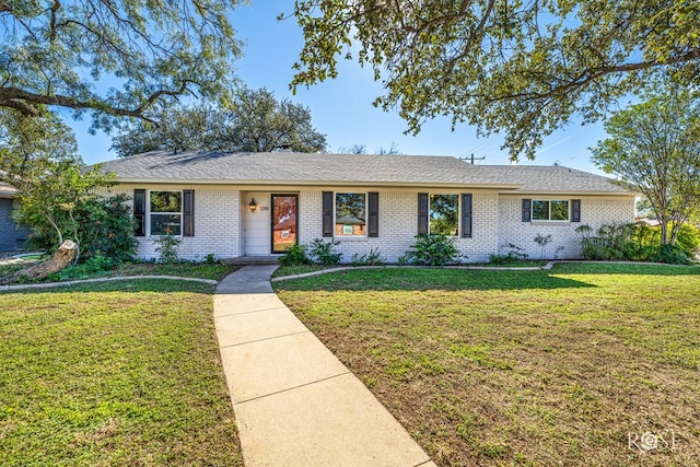 ranch-style home with a front lawn