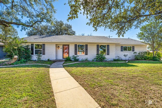 ranch-style home with a front lawn