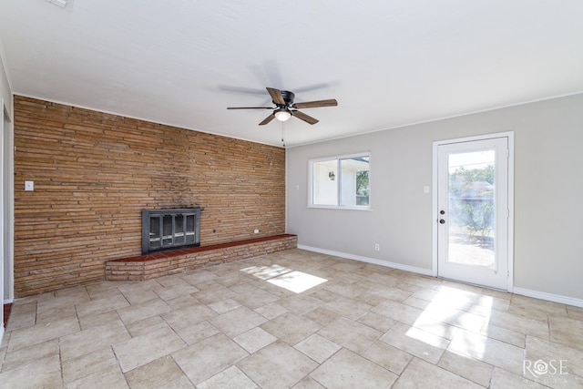 unfurnished living room featuring ceiling fan and a fireplace