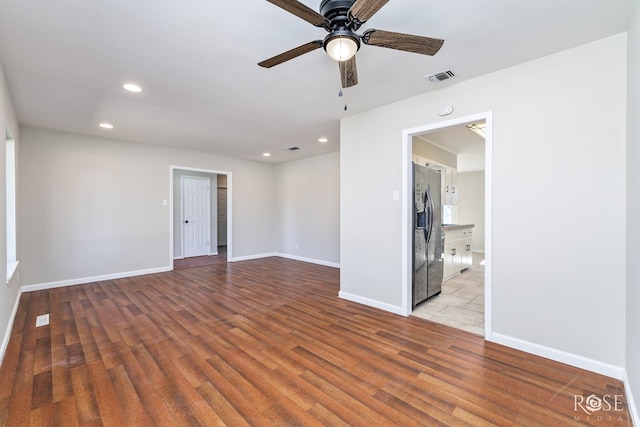 unfurnished room with ceiling fan and light hardwood / wood-style floors