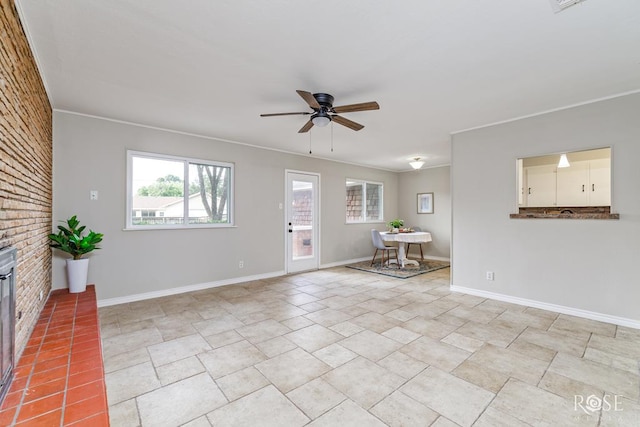 3119 Woodland Cir, San Angelo, TX 76904 - living room with baseboards, ceiling fan, and brick wall
