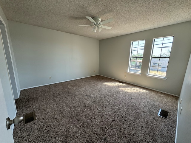 carpeted empty room with ceiling fan and a textured ceiling