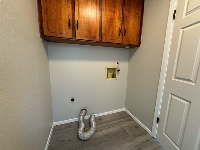 clothes washing area featuring cabinets, washer hookup, hardwood / wood-style floors, and electric dryer hookup