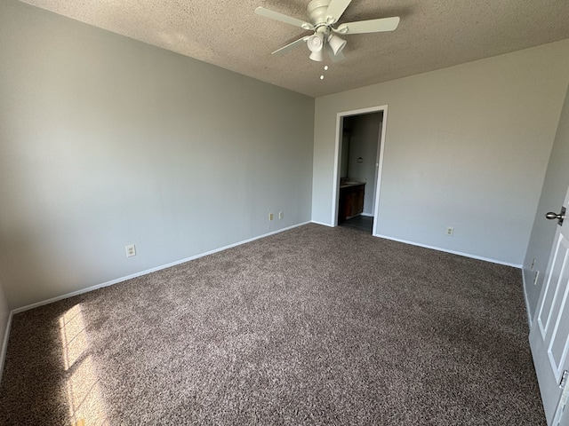 unfurnished bedroom with ceiling fan, a textured ceiling, and dark carpet