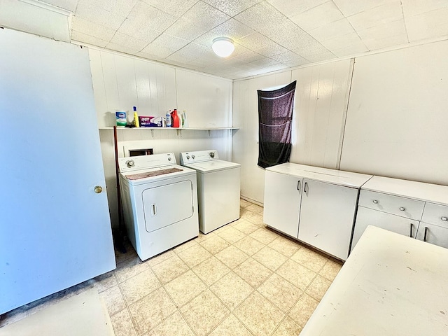 washroom with cabinets and independent washer and dryer