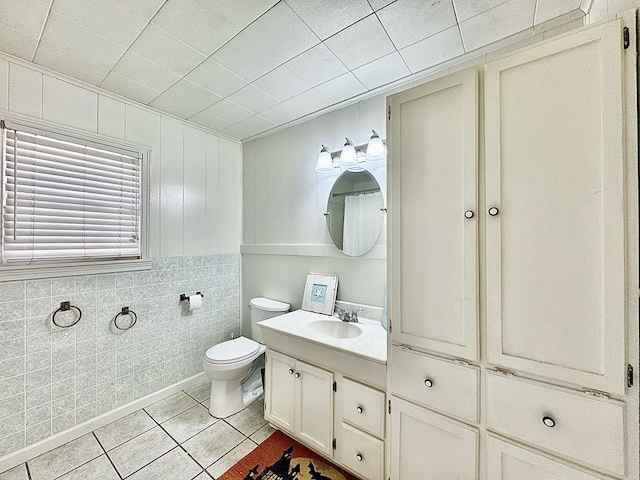 bathroom with tile patterned flooring, vanity, and toilet