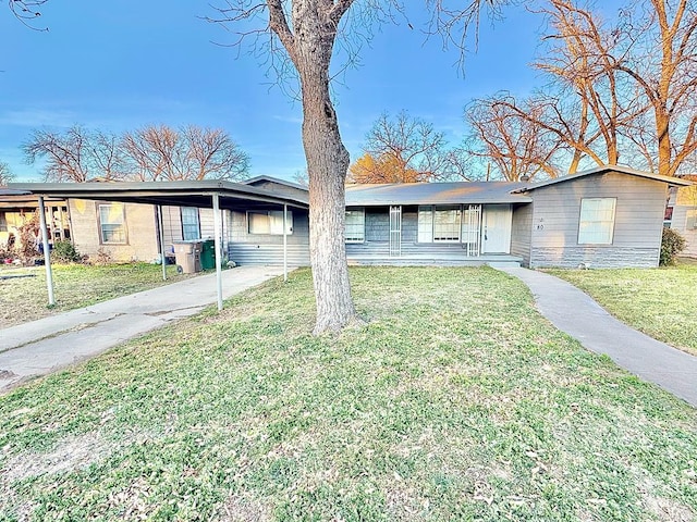 single story home featuring a carport and a front yard