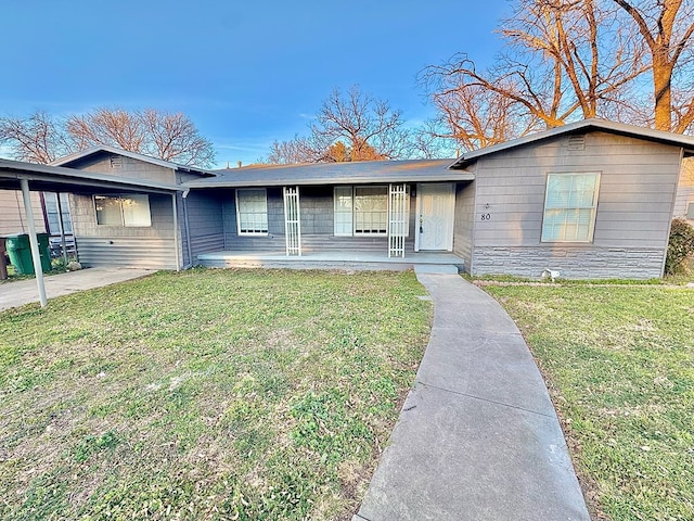 single story home with covered porch and a front yard