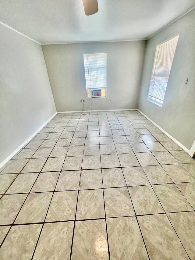 tiled spare room featuring cooling unit and ceiling fan