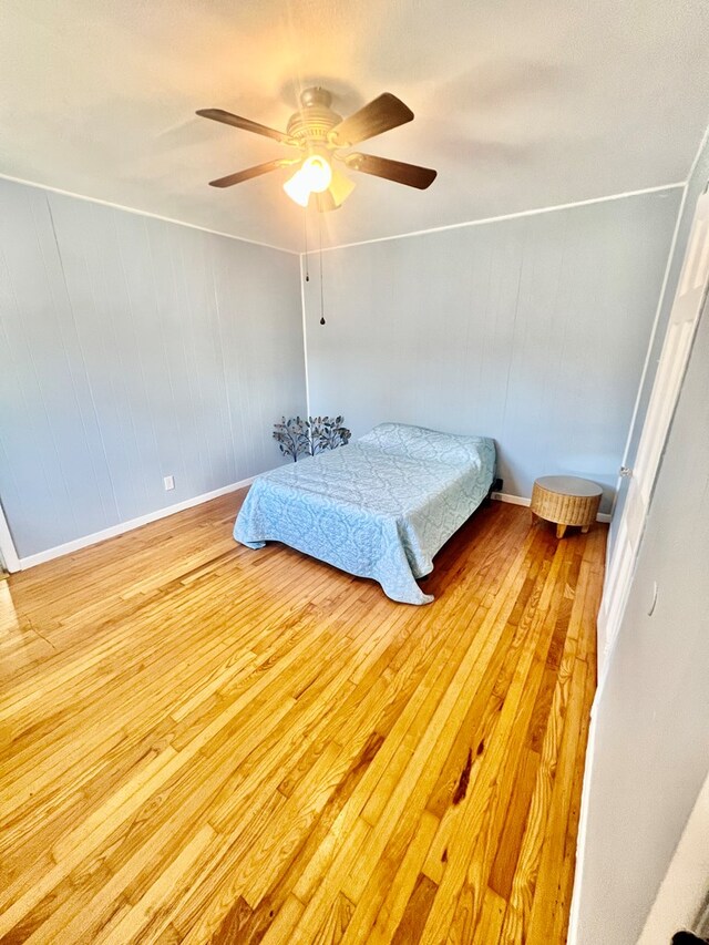 bedroom featuring ceiling fan and light hardwood / wood-style floors