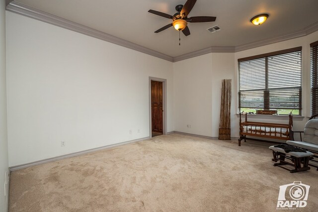 unfurnished room featuring ornamental molding, light carpet, and ceiling fan