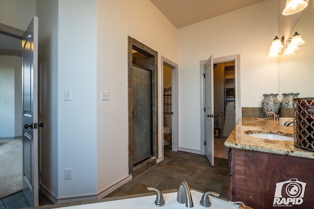 bathroom featuring walk in shower, vanity, and toilet