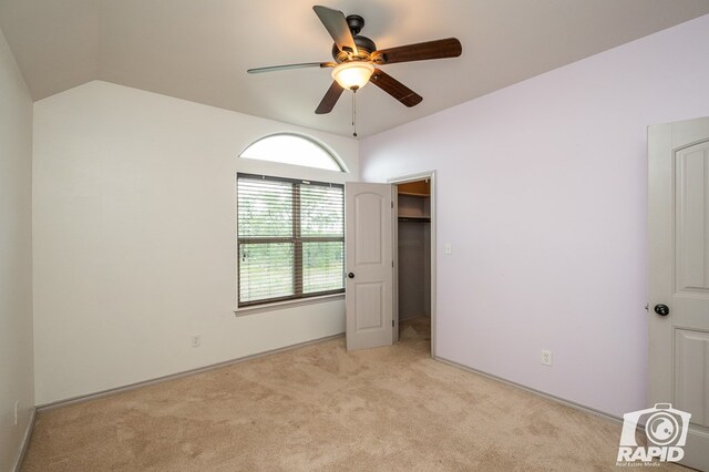 unfurnished bedroom with vaulted ceiling, light carpet, and ceiling fan