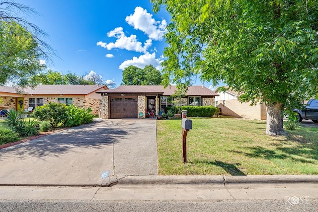 1103 E 43rd St, San Angelo, TX 76903 - single story home featuring an attached garage, driveway, a front yard, and brick siding