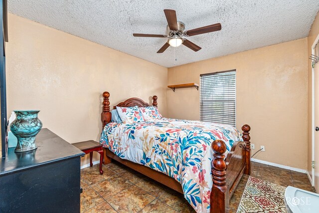 1103 E 43rd St, San Angelo, TX 76903 - tiled bedroom with a textured ceiling and ceiling fan