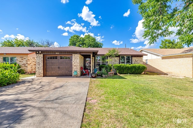 1103 E 43rd St, San Angelo, TX 76903 - single story home featuring a garage, driveway, brick siding, and a front lawn